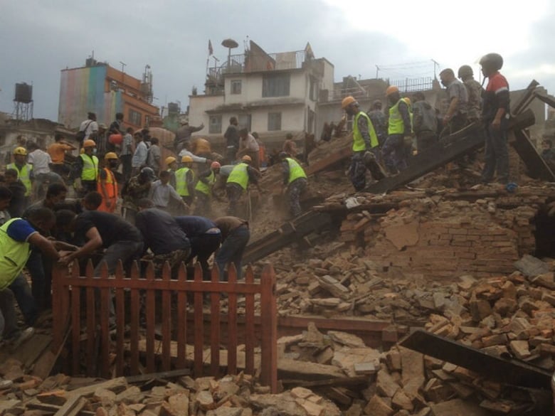 Rescuers clear the debris at Durbar Sqaure after an earthquake in Kathmandu, Nepal, Saturday, April 25, 2015.